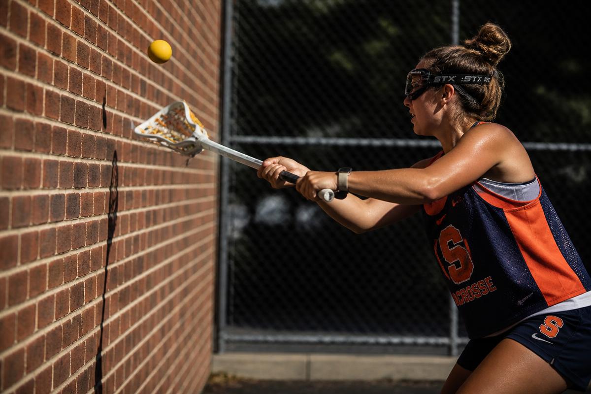 Wall ball repetitions against a brick wall
